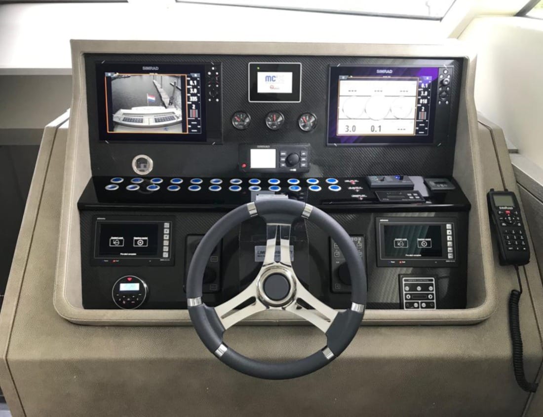 Helm station of a Phantom 79 yacht (P-Series) with steering wheel and navigation screens.