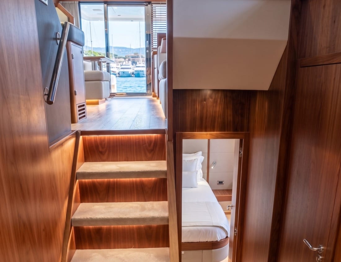 Stairway inside a Phantom 65 Coupé (P-Series) leading between the bedroom and main deck.