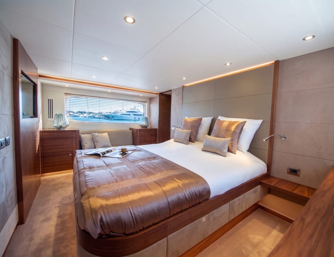 Bedroom of a Phantom 65 Coupé yacht (P-Series) with double bed and large window.