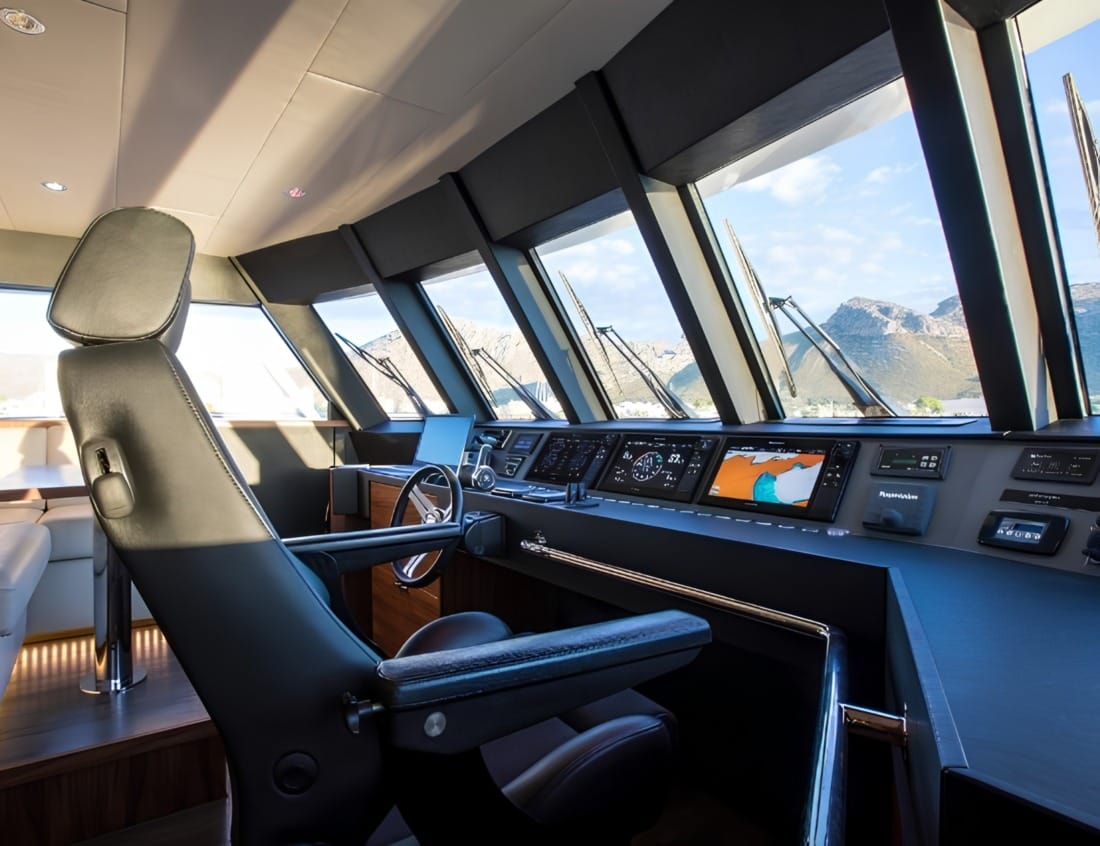 Helm station of a VDHY Explorer 2400 yacht with navigation screens and captain’s chair (EX-Series)