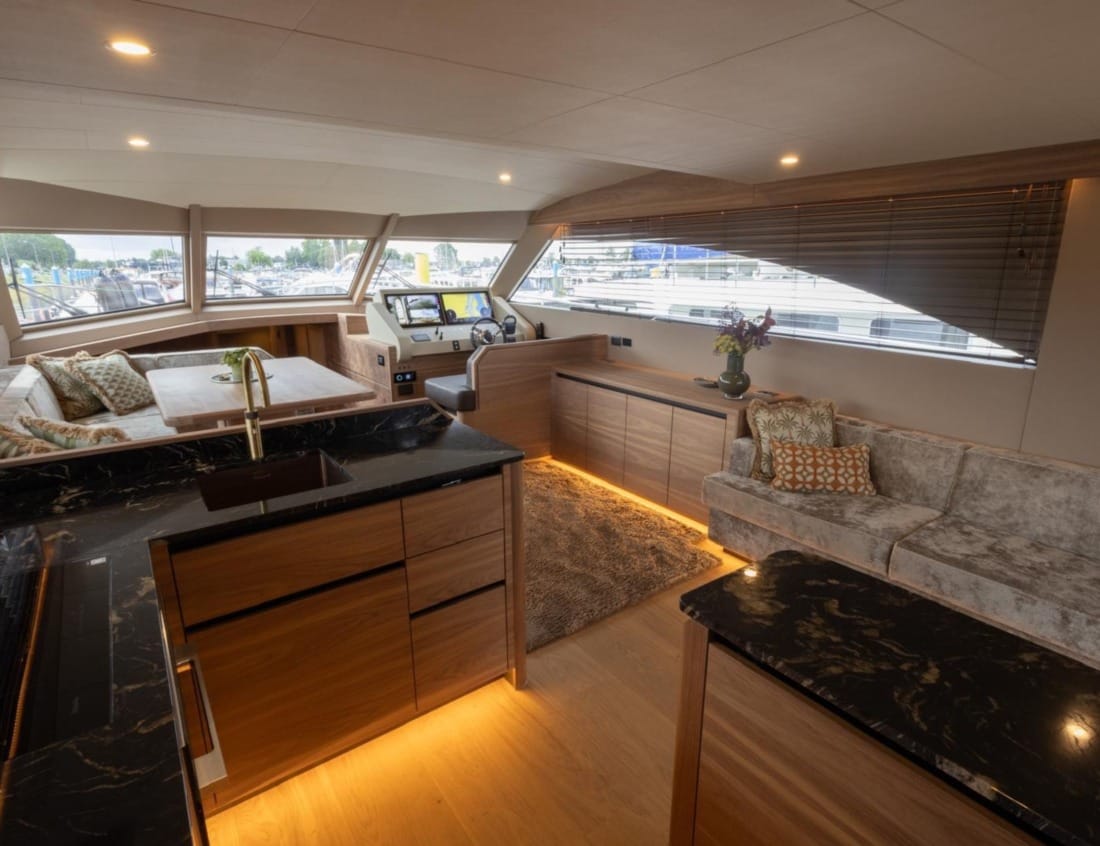 Interior of an 2026 Exclusive Deluxe 2000 Sportbridge Interior - Exclusive Series with dining area, lounge and kitchen.