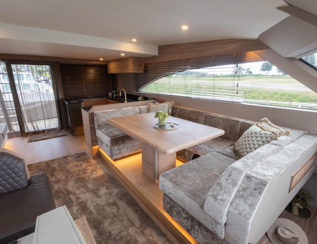 Interior of an 2026 Exclusive Deluxe 2000 Sportbridge Interior - Exclusive Series with dining area, lounge and kitchen.