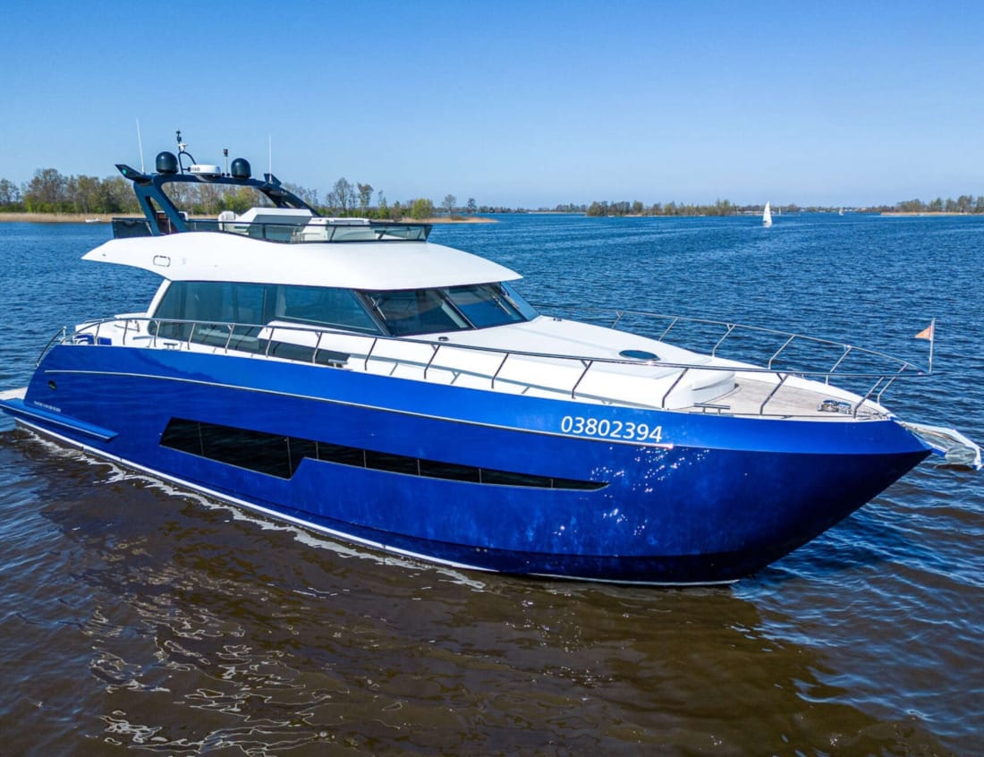 Aerial rear view of a blue Phantom 70 yacht on the water