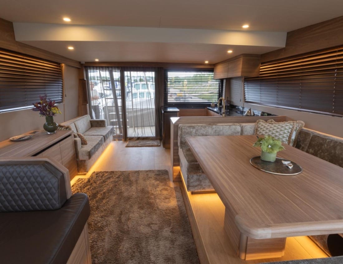 Interior of an 2026 Exclusive Deluxe 2000 Sportbridge Interior - Exclusive Series with dining area, lounge and kitchen.