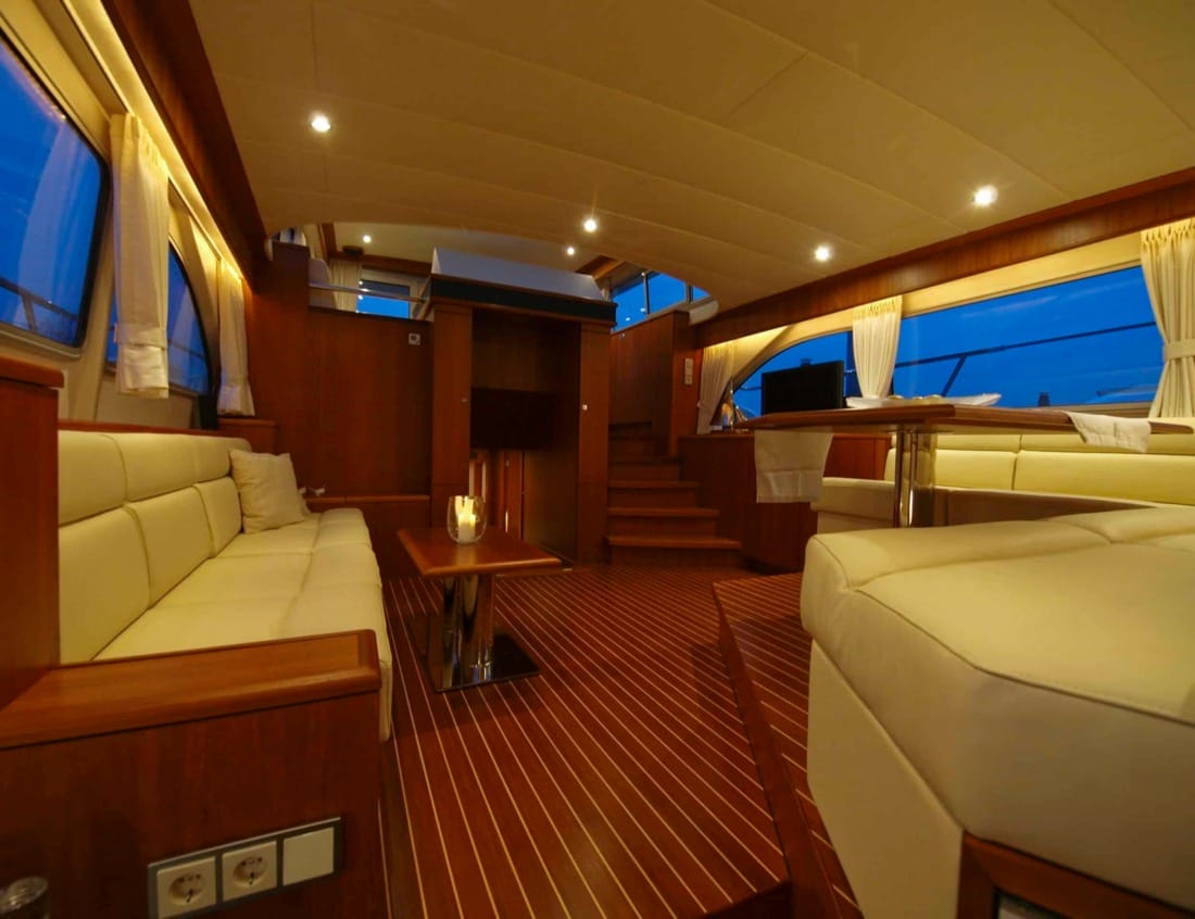 Interior of a Dynamic Deluxe 1700 - Dynamic Series with lounge seating, dining area and wood flooring.