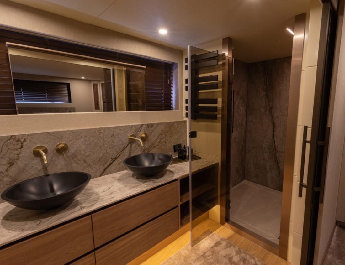 Bathroom of a 2026 Exclusive Deluxe 2000 Sportbridge Interior - Exclusive Series with double sinks.