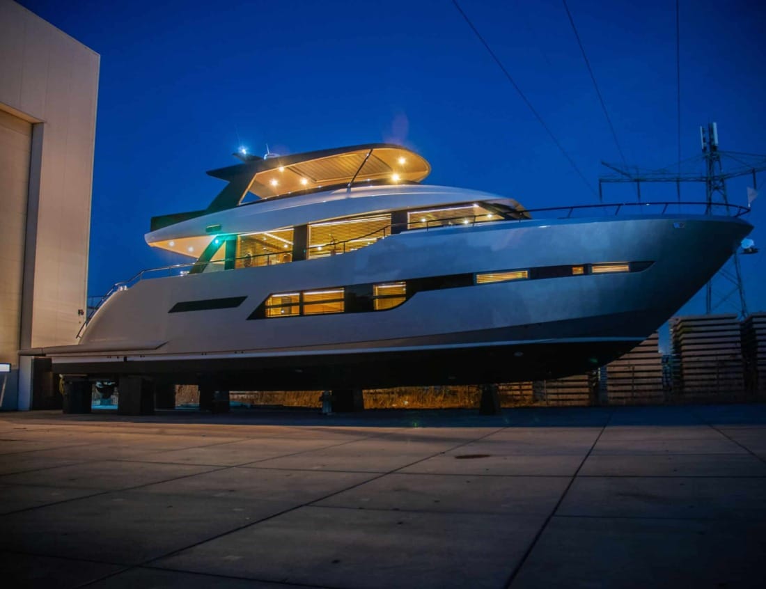 Phantom 80 yacht illuminated at night at a shipyard