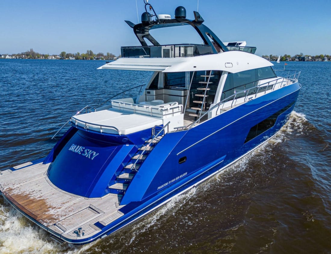 Aerial rear view of a blue Phantom 70 yacht on the water