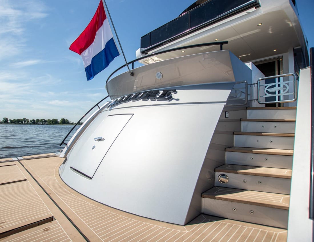 Aft stairs of a Phantom 80 Van der Heijden yachts with Dutch flag.
