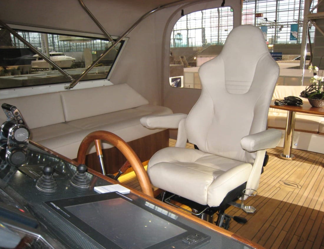 Helm area of a Dynamic Deluxe 1500 - Dynamic Series with captain’s chair and seating.