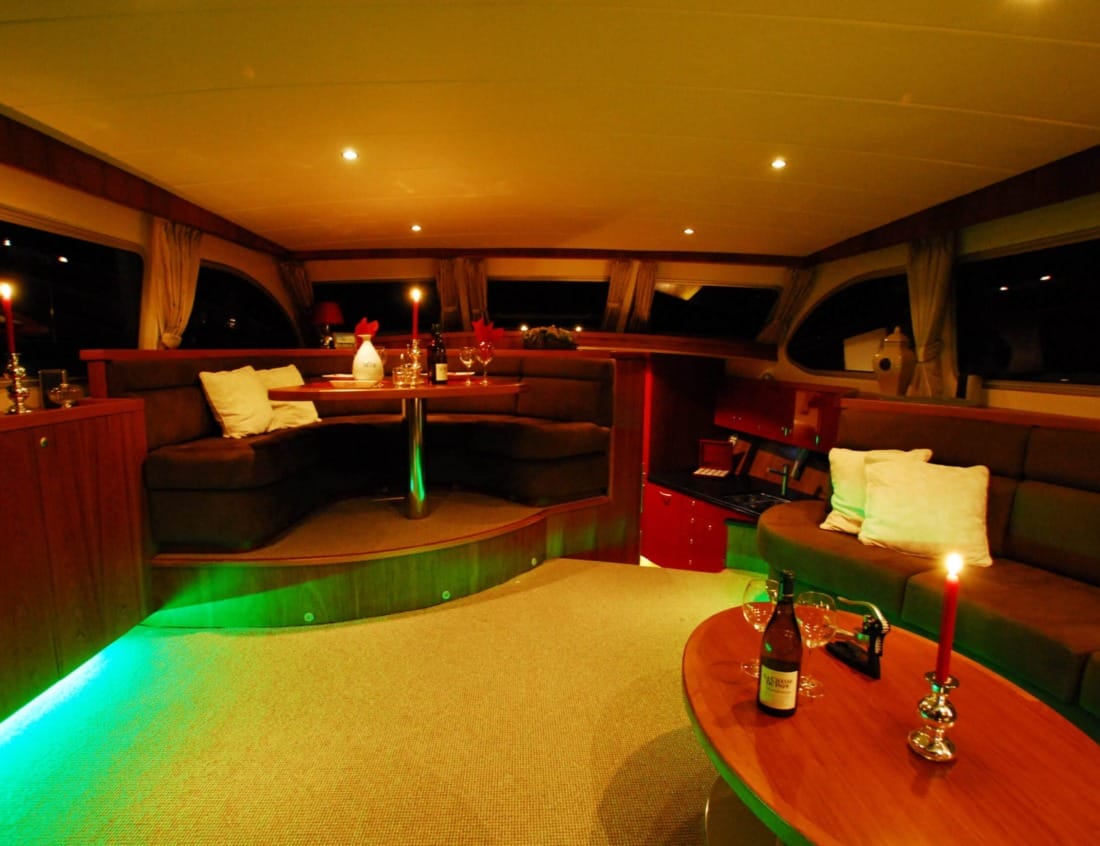Dynamic Deluxe 2100 - Dynamic Series with lounge seating, dining table and ambient lighting at night.