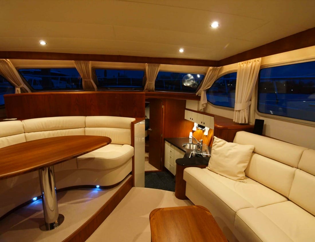 Interior of a Dynamic Deluxe 1500 - Dynamic Series with seating areas, dining table and compact galley.