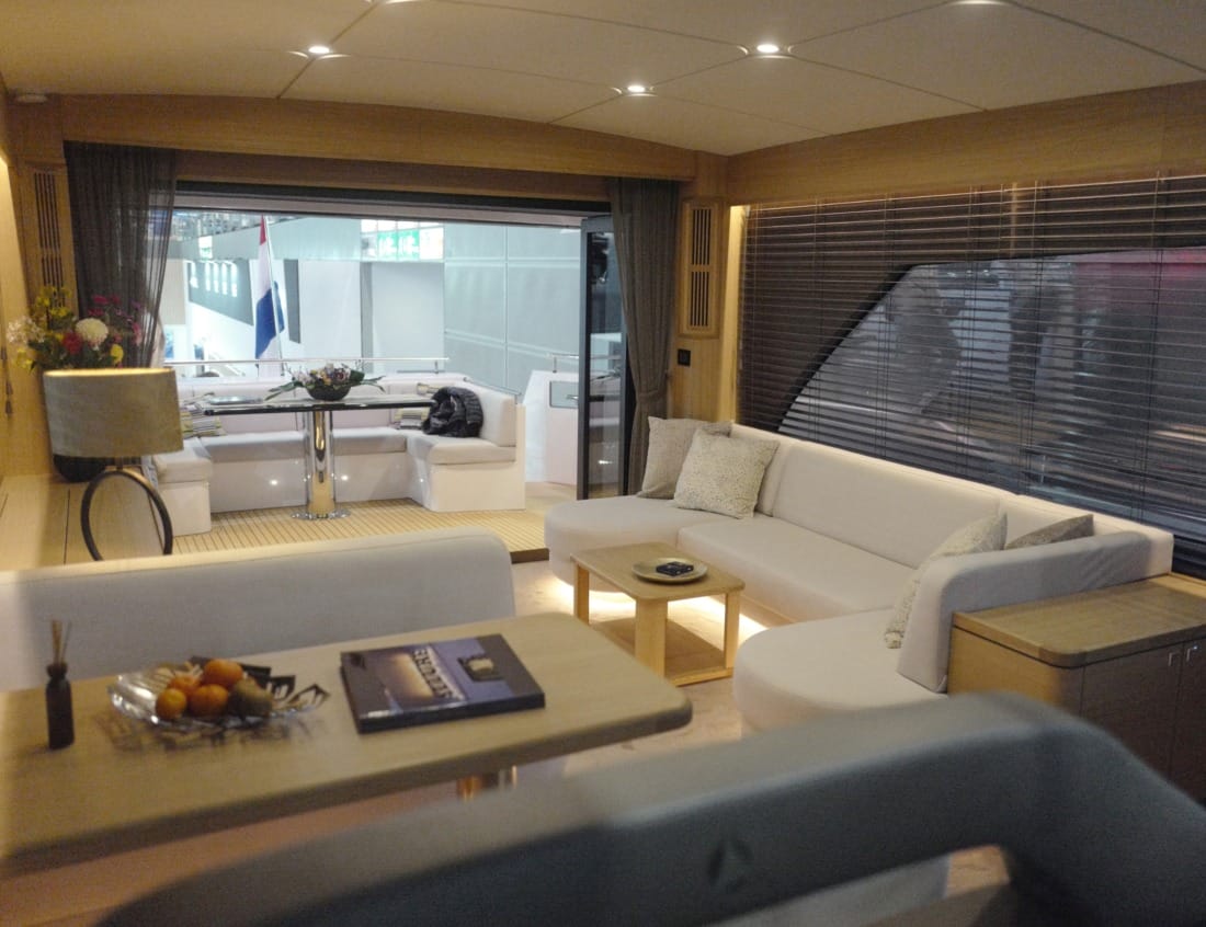 Interior lounge of a Traveller 63 - Traveller Series with white seating, coffee table and large panoramic windows.