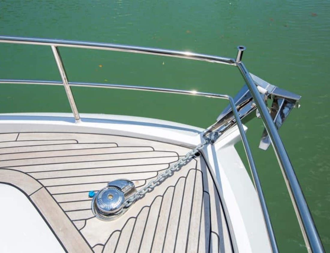 Foredeck of a Hayden Sedan - Hayden Series with teak decking, anchor, chain and stainless steel railings.