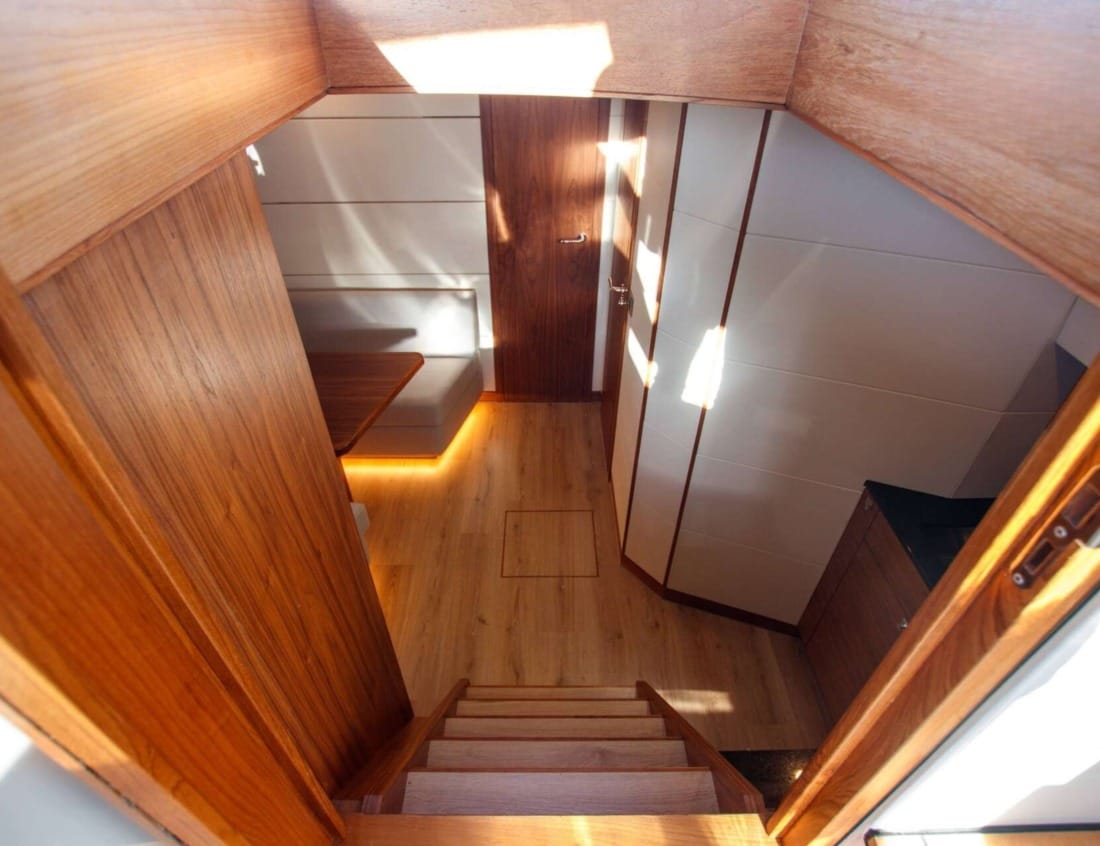 Interior stairway of a Cruiser 1350 - Cruiser series with wood paneling and ambient lighting.