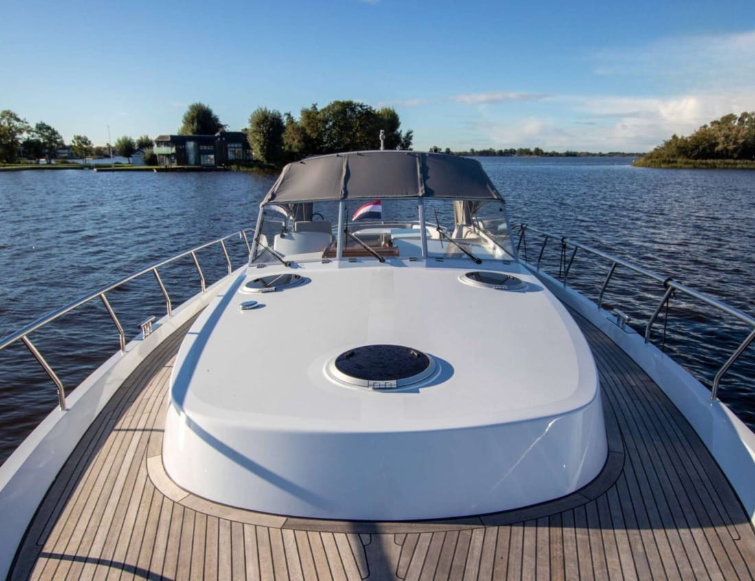 Foredeck of a Cruiser 1350 - Cruiser series with deck hatches, teak side decks and cockpit canopy.