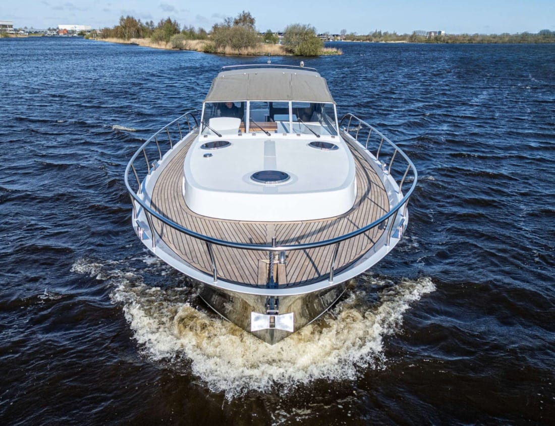 Foredeck of a Cruiser 1350 - Cruiser series with deck hatches, teak side decks and cockpit canopy.
