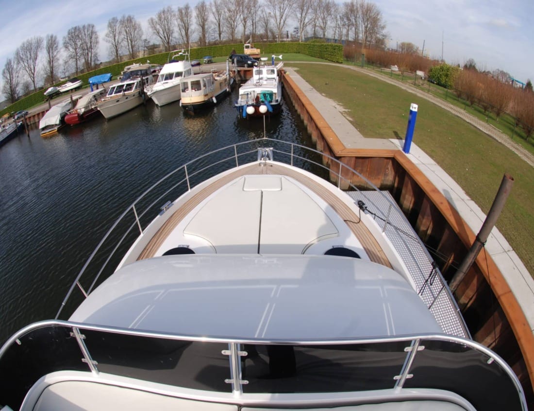 Foredeck of a Hayden Flybridge - Hayden Series viewed from above, with sunpad seating and stainless steel railings.