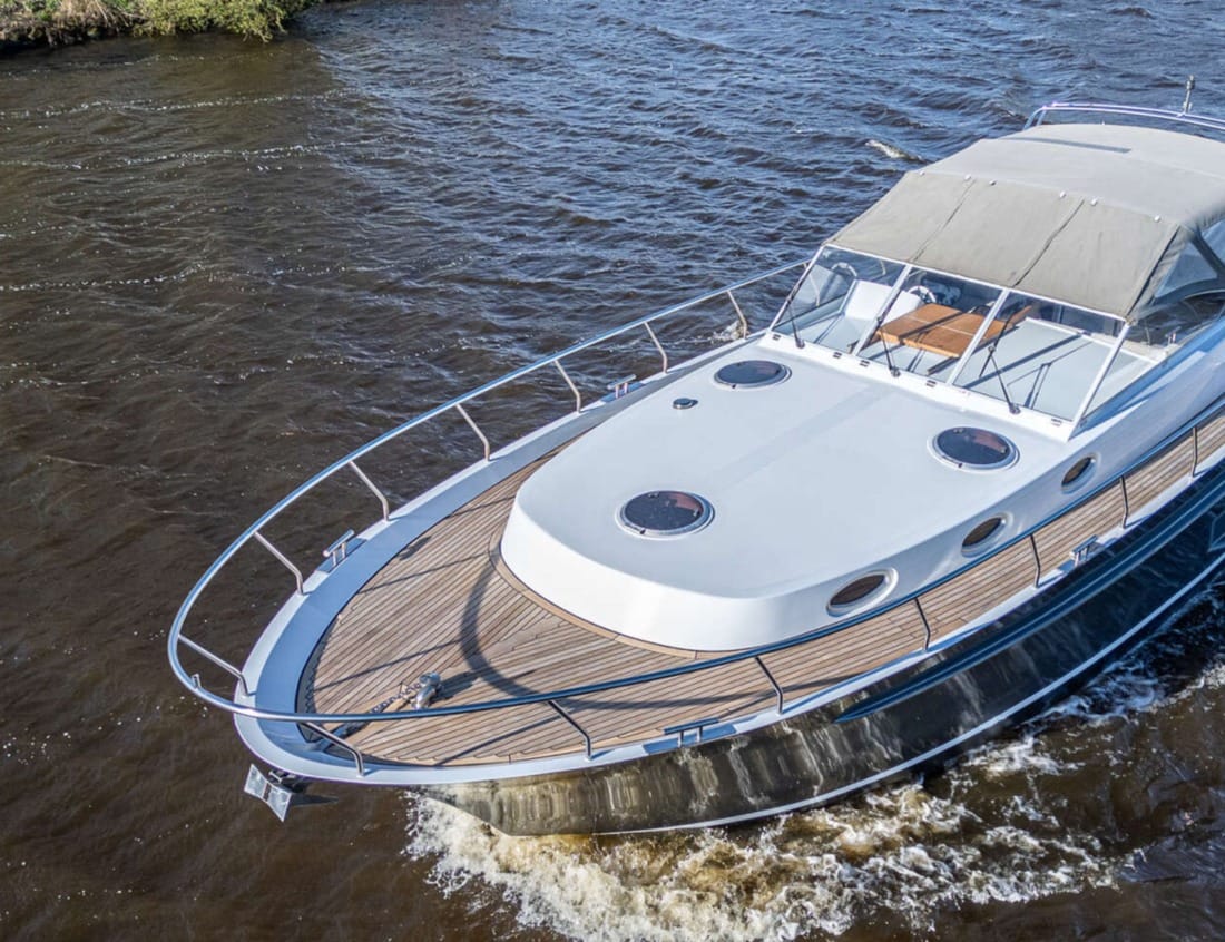 Foredeck of a Cruiser 1350 - Cruiser series with deck hatches, teak side decks and cockpit canopy.