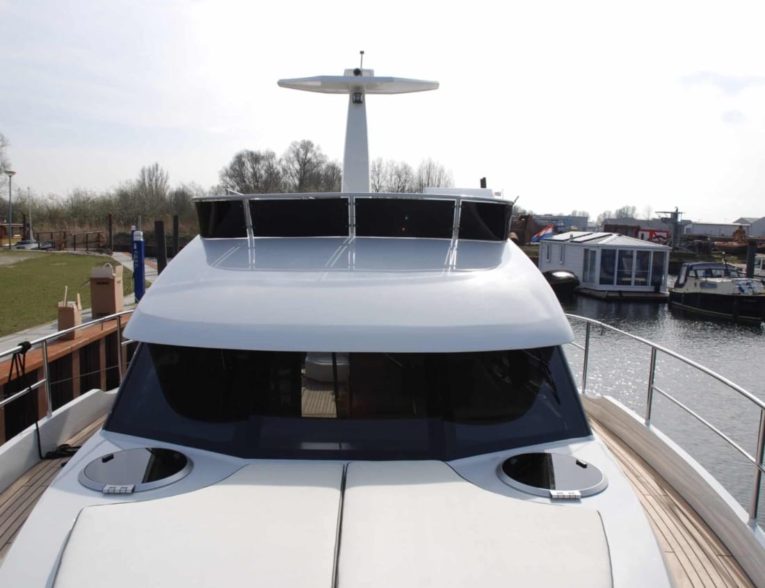 Front view of a Hayden Flybridge - Hayden Series with foredeck sunpad, deck hatches and flybridge structure.