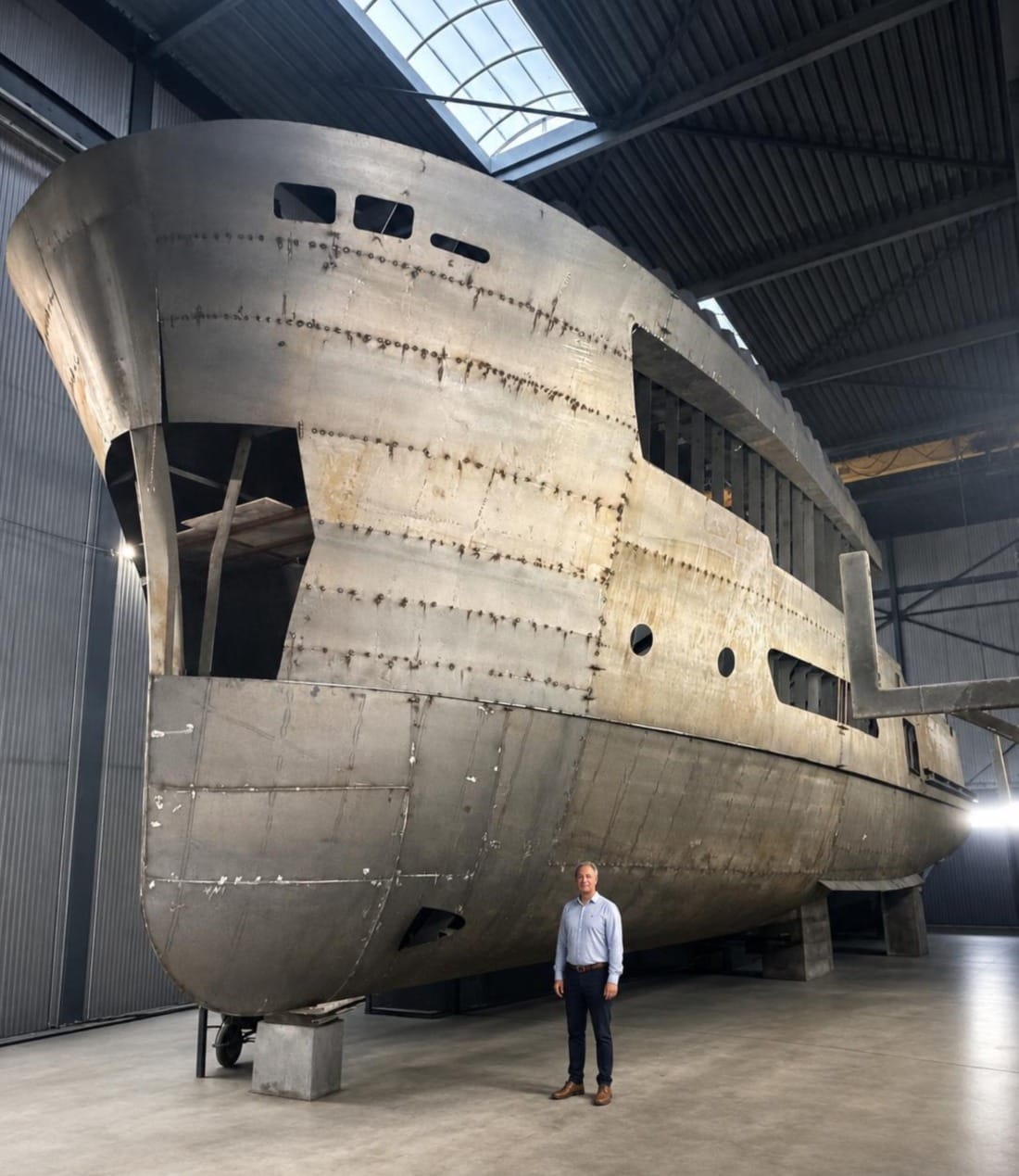 Ronald van der Heijden standing next to a large VDH Yacht in the making